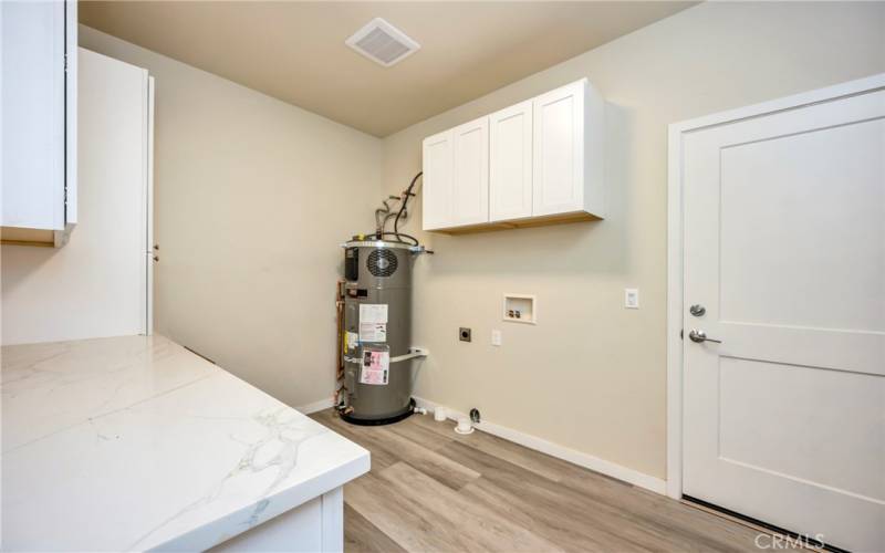 Spacious laundry with cabinets