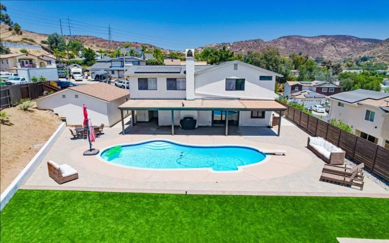 Backyard with a pool and paid for solar.