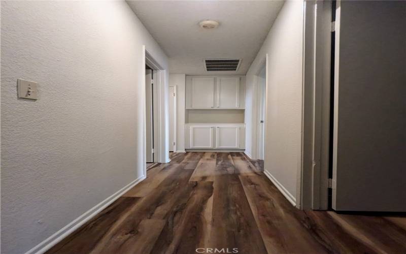 Hallway with storage cabinets.