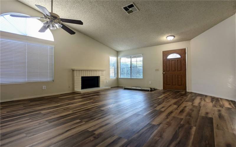 Huge living space with vaulted ceilings & fireplace.