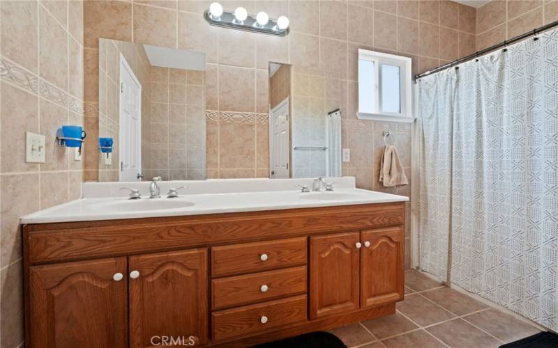 Primary bathroom with dual sinks & stall shower