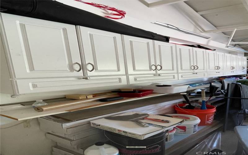 garage has storage cabinets on three walls