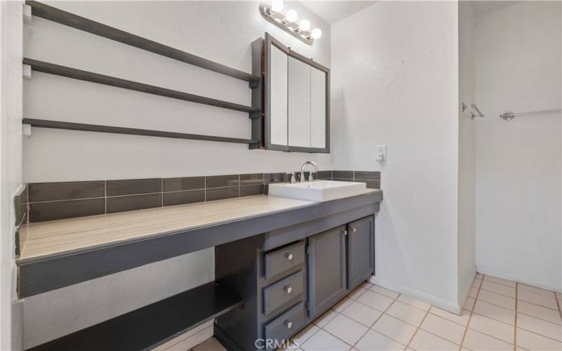 This en suite bath has a large vanity and plenty of storage. The tub/shower combination in this room is perfect.