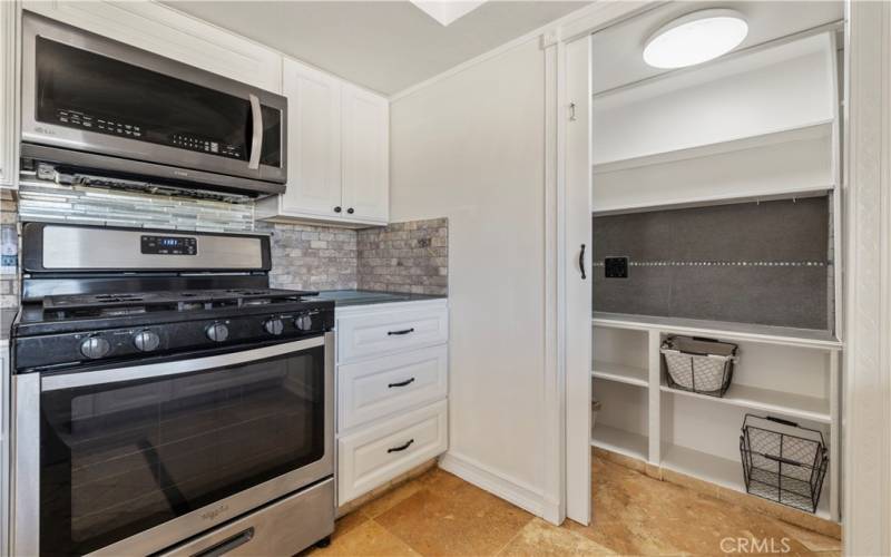 A french pocket door opens to a walk in pantry for the extra's needed to keep the chef happy!