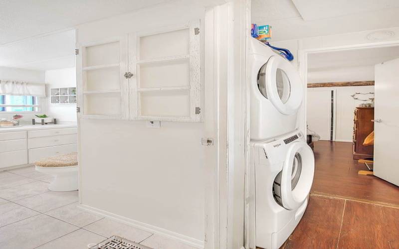 Hallway laundry area, washer and dryer included.