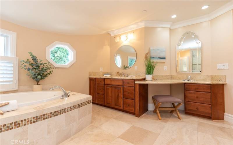 Dressing counter and beautiful lighting in the primary bath.