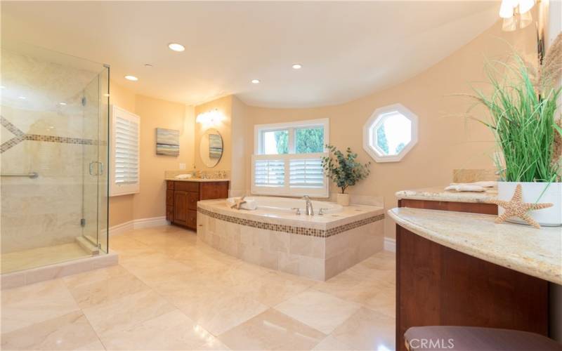 Tranquil primary bath with separate vanities.