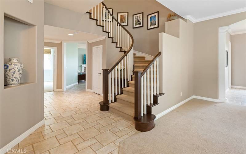 Elegant Foyer at Entry with Spiral Staircase