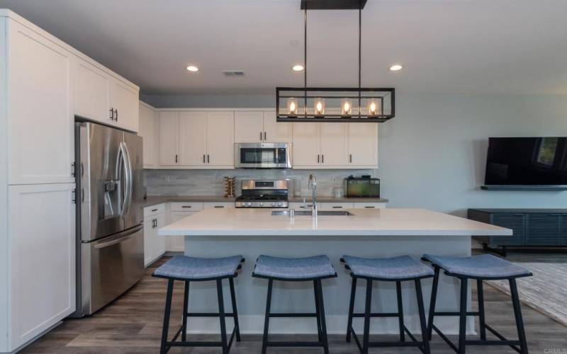 Modern kitchen with quartz countertops and stainless steel appliances