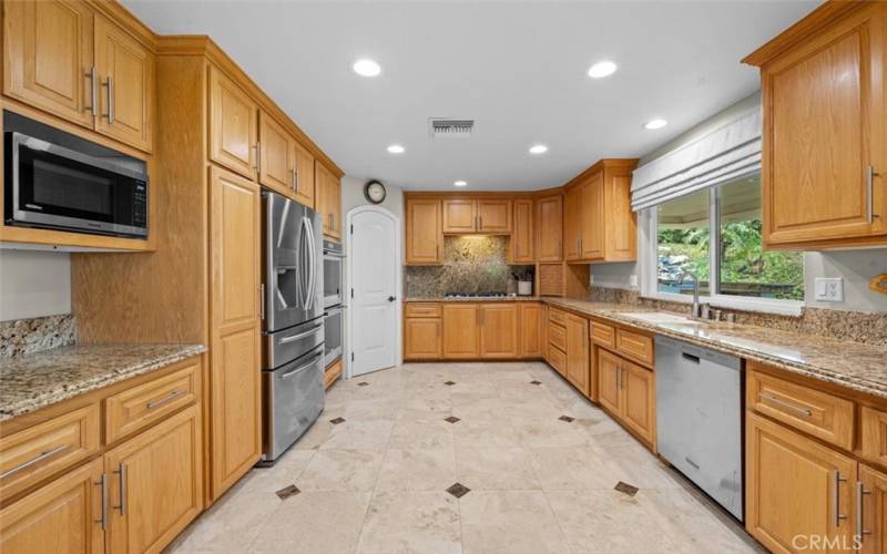 Huge upgraded kitchen is a chef's dream, complete with stainless steel appliances, a walk-in pantry, ample cabinets, and counter space