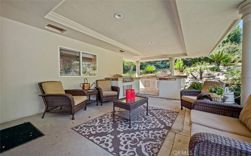 Relax under the covered patio to the sound of the natural looking waterfall.