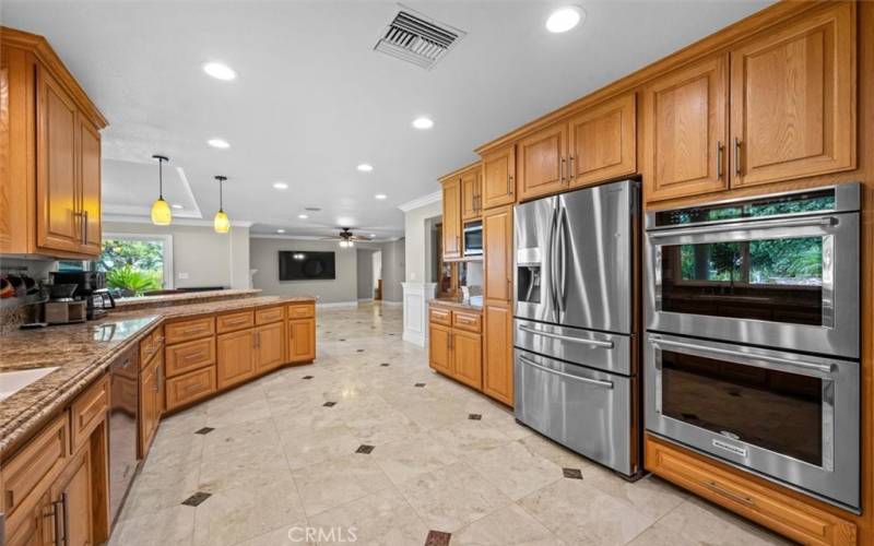 Huge upgraded kitchen is a chef's dream, complete with stainless steel appliances, a walk-in pantry, ample cabinets, and counter space