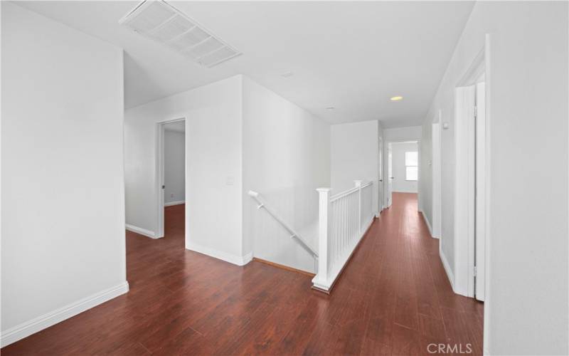 catwalk upstairs leading to primary bedroom