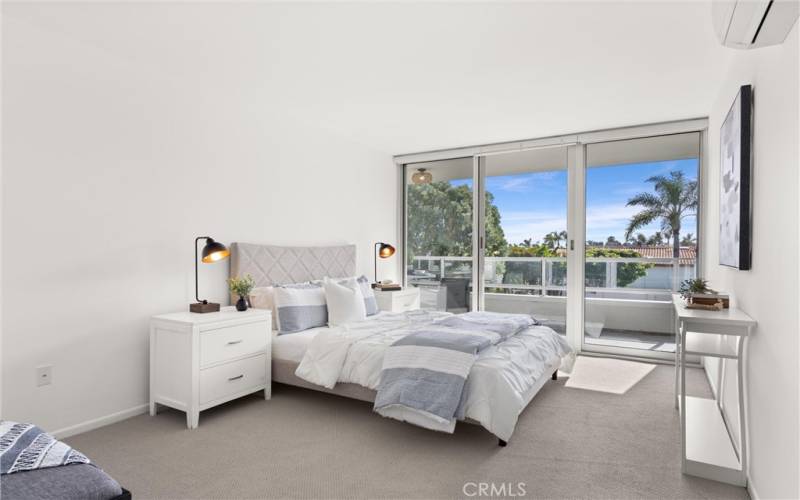 The first bedroom has floor-to-ceiling windows and slider, along with its own mini-split HVAC system