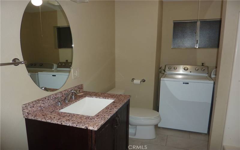 There is a full bath on the main level, and it has the laundry area in it too