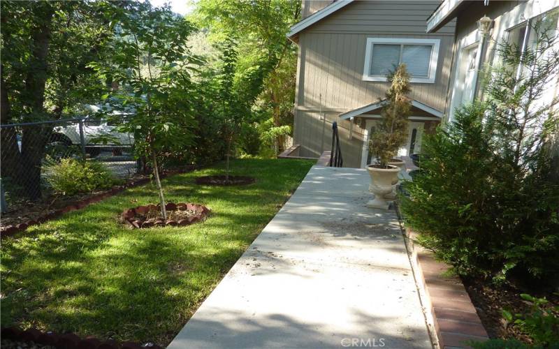 Walk through the landscaped area from the parking area and garage to get to the front door