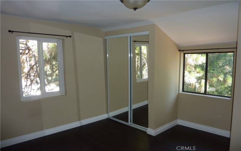 The fourth bedroom also has  mirrored closet doors