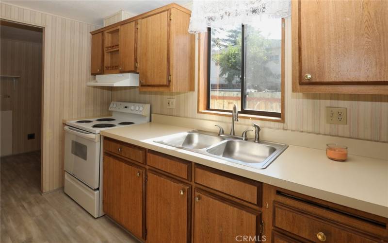 Kitchen with ample cabinets and window for light.