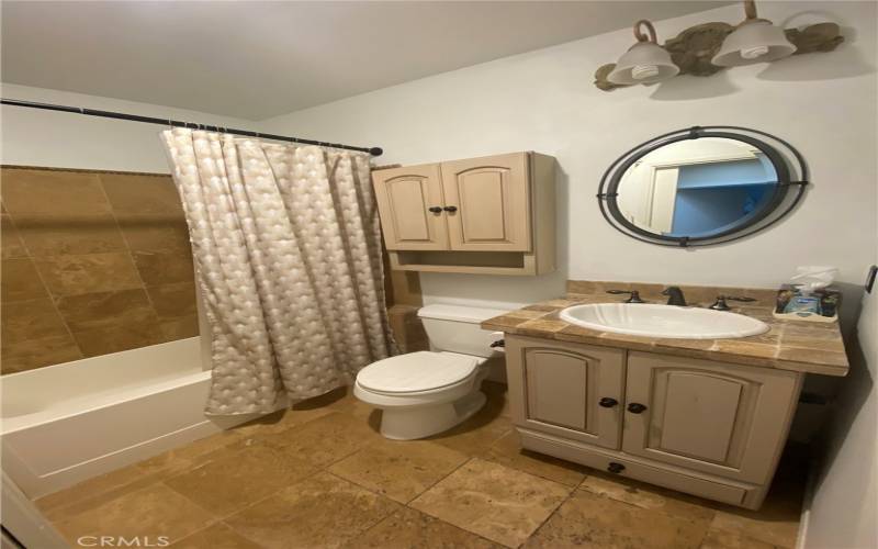 Full bathroom with tub and shower