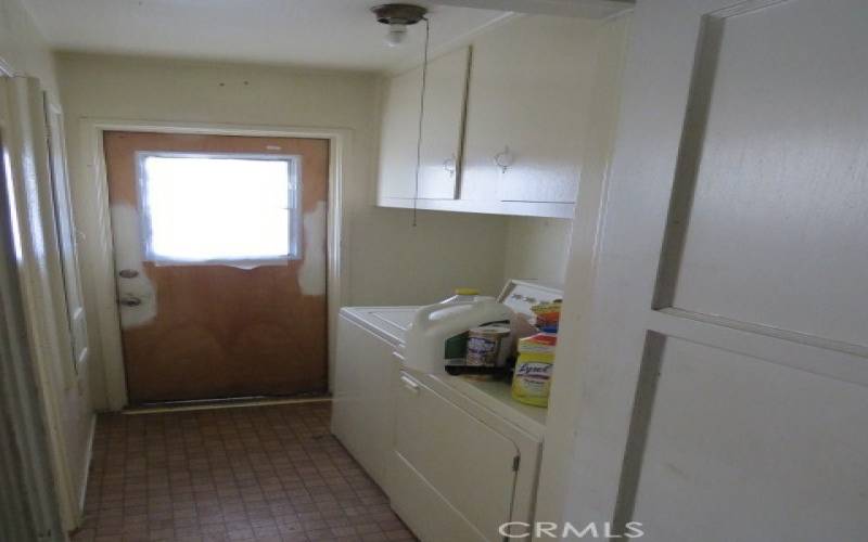 Hallway View Of Laundry Area and Exit To The Yard.