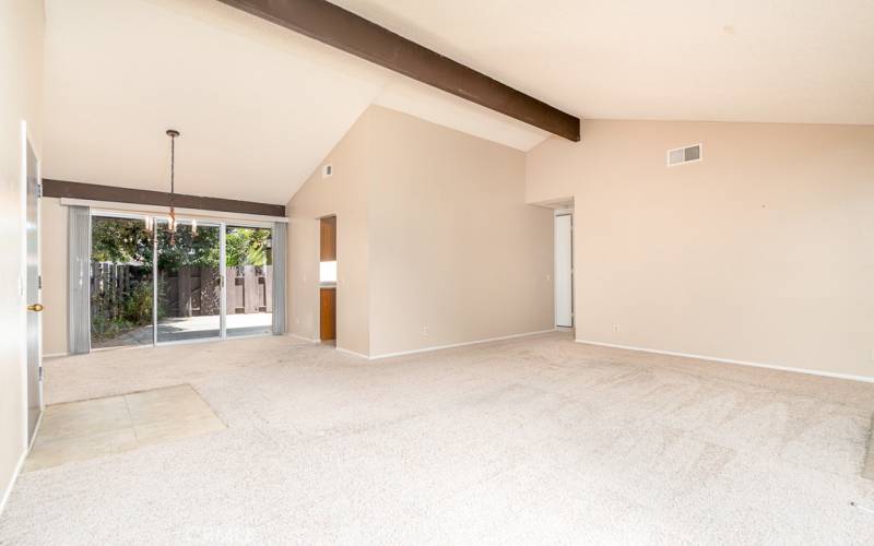 Dining area adjacent to living room with sliding door to patio