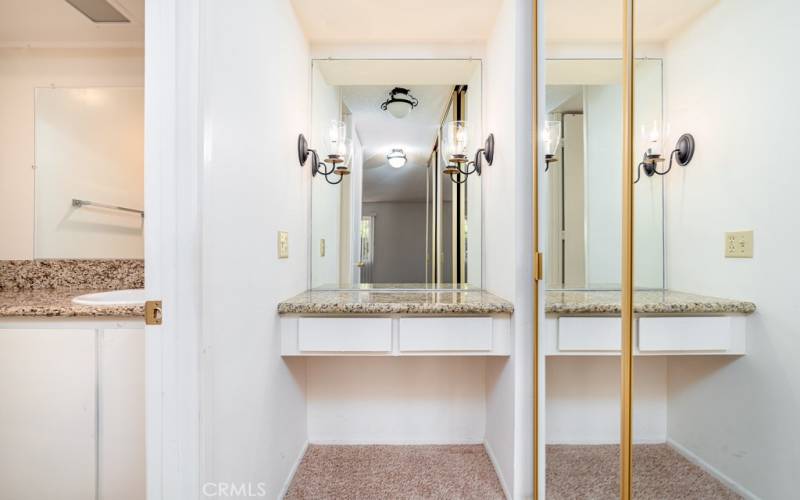 Vanity area with mirrored wardrobes