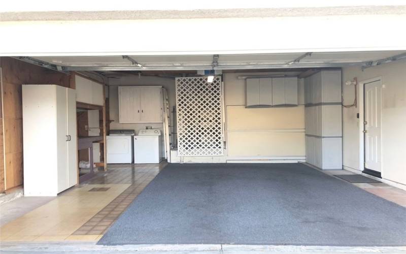 garage with washer & dryer & storage cabinets