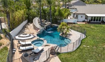 Pool with slide, waterfall, and spa