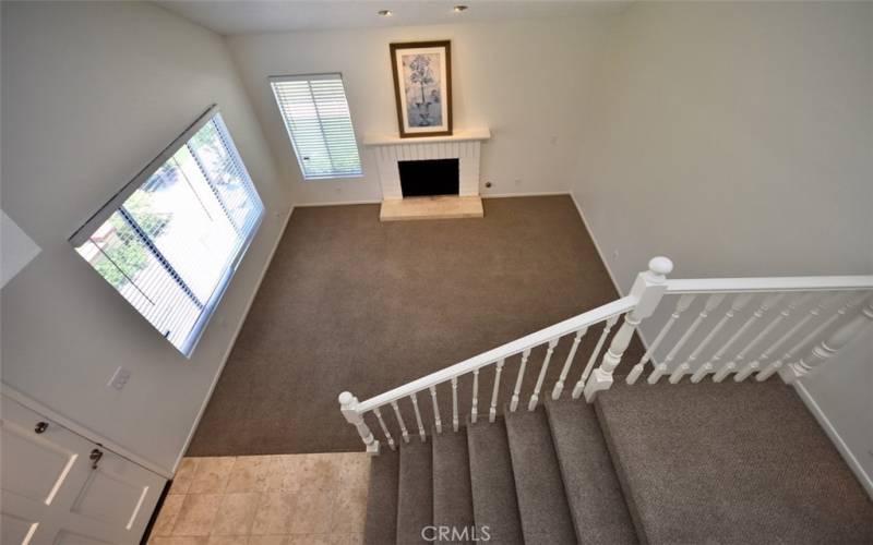 Ascend the carpeted staircase to find a spacious landing leading to the bedrooms, each offering ample closet space and natural light.