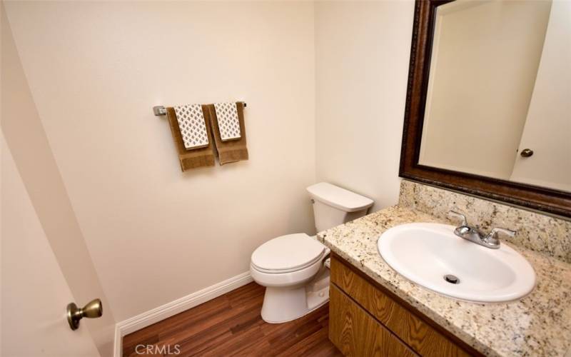 Conveniently located half bath with sparkling counter tops.