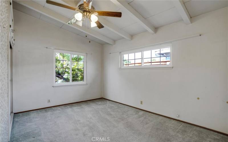 Bedroom #3 with beamed ceiling and fan.