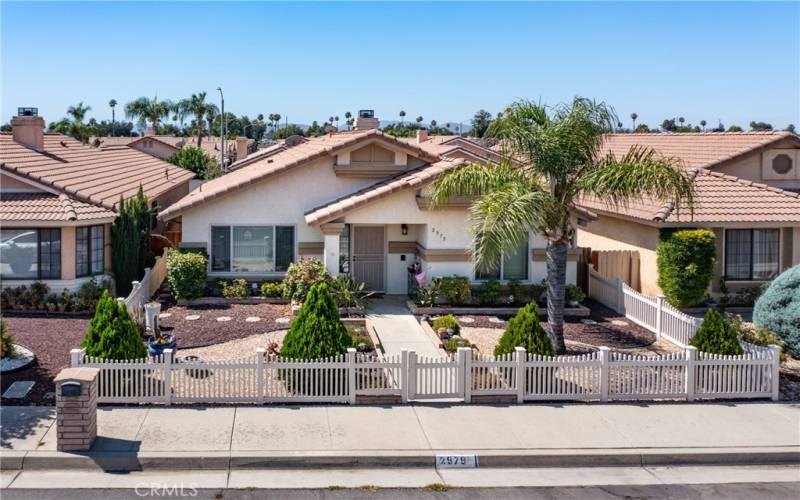 Fully fenced front yard with drought resistant landscaping and rock.