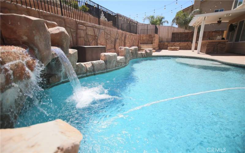 Indulge in luxury with the stunning pool, complete with an enchanting water grotto that transforms your backyard into a private oasis.