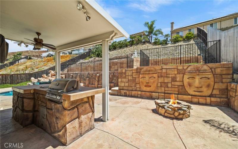 Enjoy outdoor living at its finest with the covered patio, featuring a premium BBQ grill with an additional burner, perfect for entertaining and dining al fresco, offering both comfort and convenience.