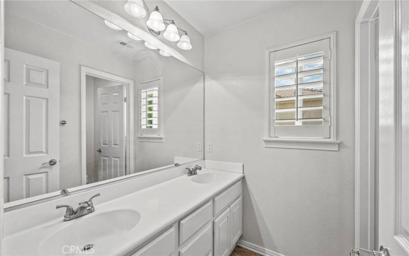 The upstairs full bath is designed for convenience featuring dual sinks that provide ample space.