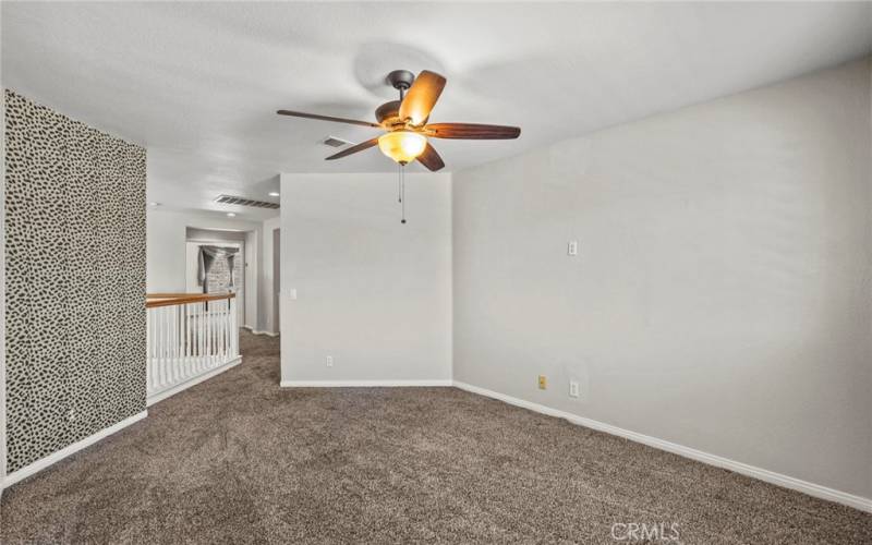 The spacious upstairs loft is enhanced by a stylish ceiling fan which ensures a pleasant airflow, making the loft an ideal space for relaxation, entertainment, or creative pursuits.