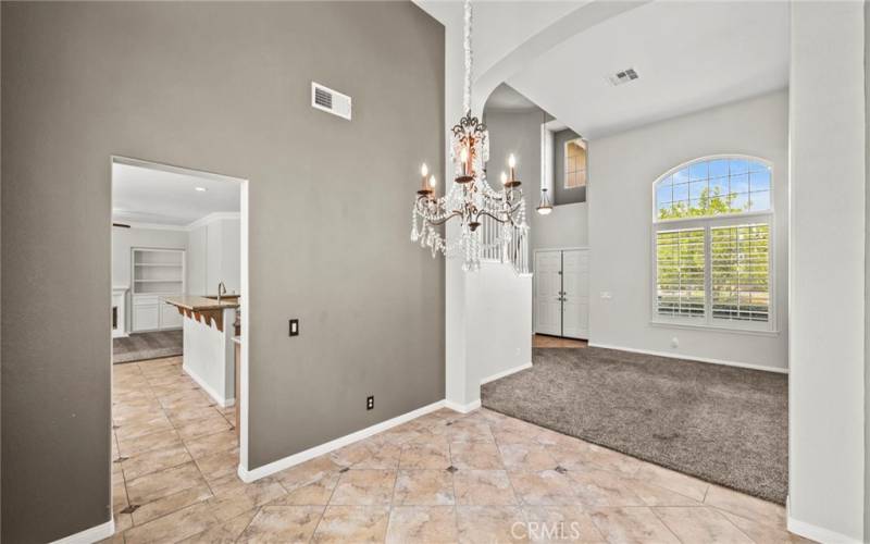 Exquisite formal dining area designed for those who appreciate the art of fine dining, enhanced by sophisticated lighting fixtures.