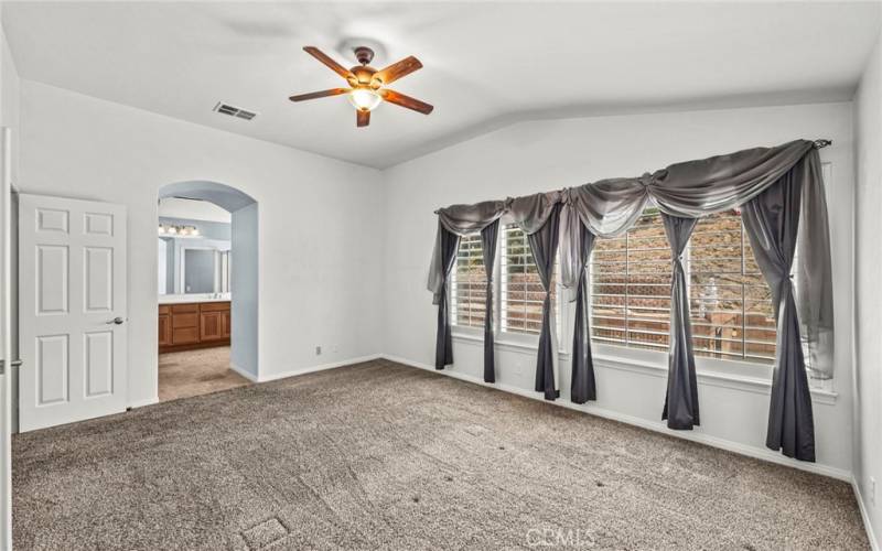 Step into the primary bedroom, designed for ultimate relaxation and comfort. This spacious retreat features a thoughtfully planned layout with ample room for a king-sized bed and elegant furnishings.