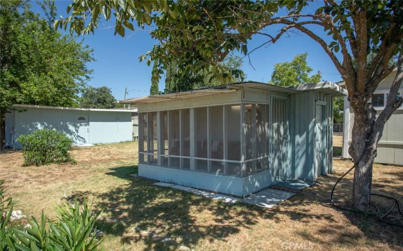 Screened room under shade trees.