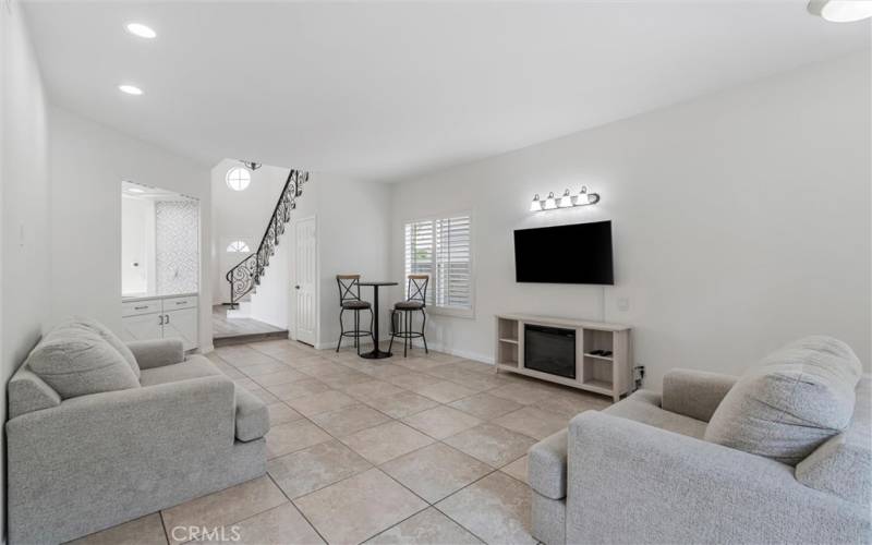 Family room with remodeled wet bar and custom made overhead wine rack