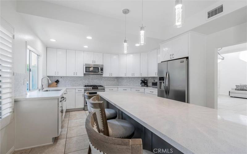 Upgraded kitchen with quartz countertops and marble backsplash