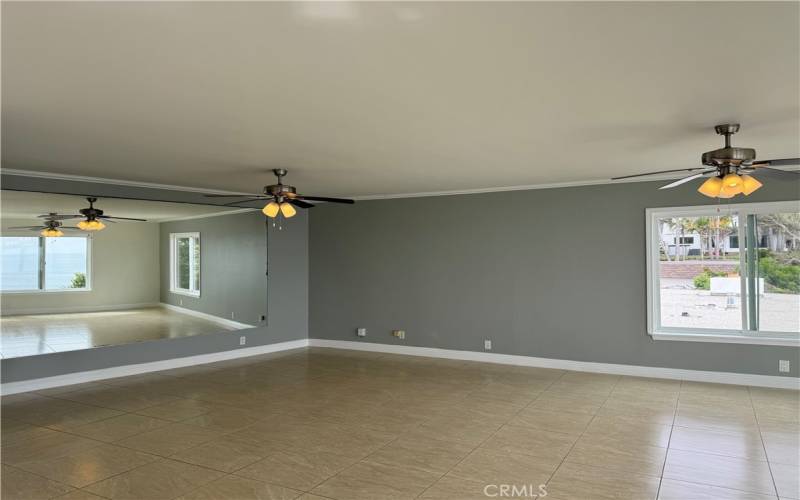 Opposite view of Living Room w/ mirrors to capture the view from all areas when your back may be to a window