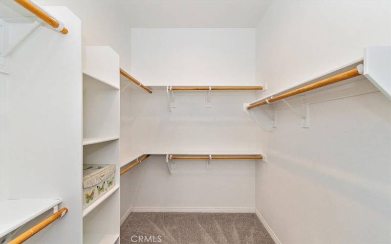 Primary bedroom closet featuring organized shelving