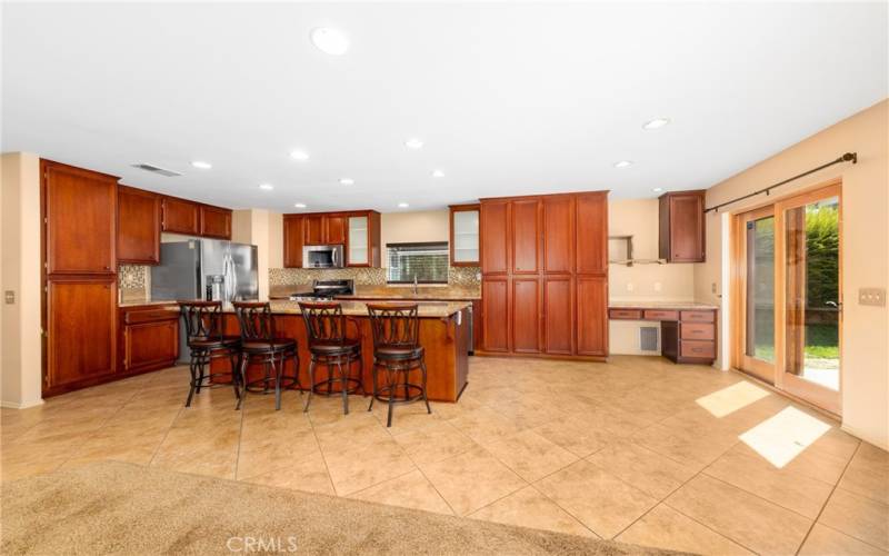 Kitchen - Cabinets to the left of the fridge appear wider in the photo. Please refer to the photo of the close up of refrigerator for a more accurate photo.