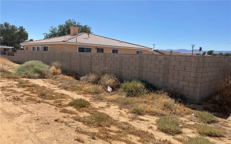 Alley view of full block wall fence from back