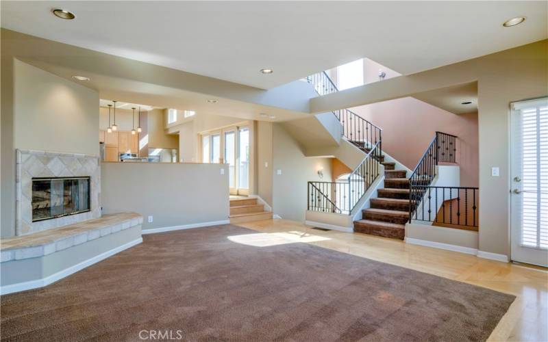 Open concept living room with beautiful tiel fireplace, soaring ceilings, great light and more