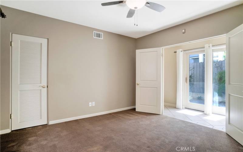 2nd downstairs bedroom with double doors leading to the hall and the sliders to the private patio/garden area