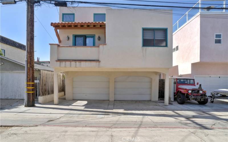 Street to alley lot allows for parking in front and rear.  2 car garage, parking for another car in front, and view of primary suite balcony