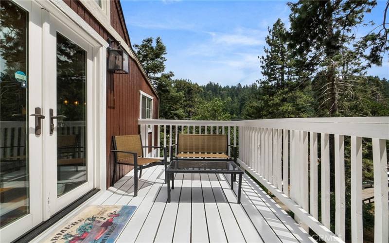 Refinished wood deck space off the kitchen. Fully private overlooking the double lot.