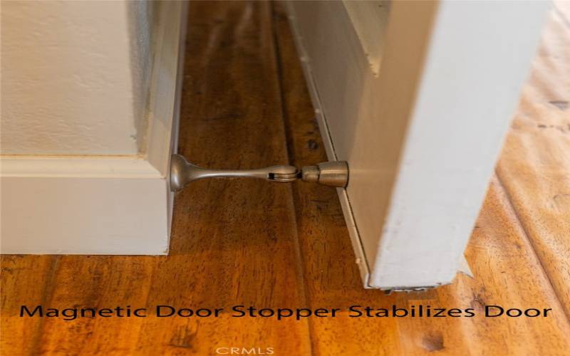 Magnetic door stopper to stabilize front door.